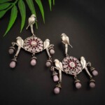 Silver and pink jhumka earrings featuring intricate traditional design with hanging pink beads, perfect for enhancing Indian ethnic outfits.