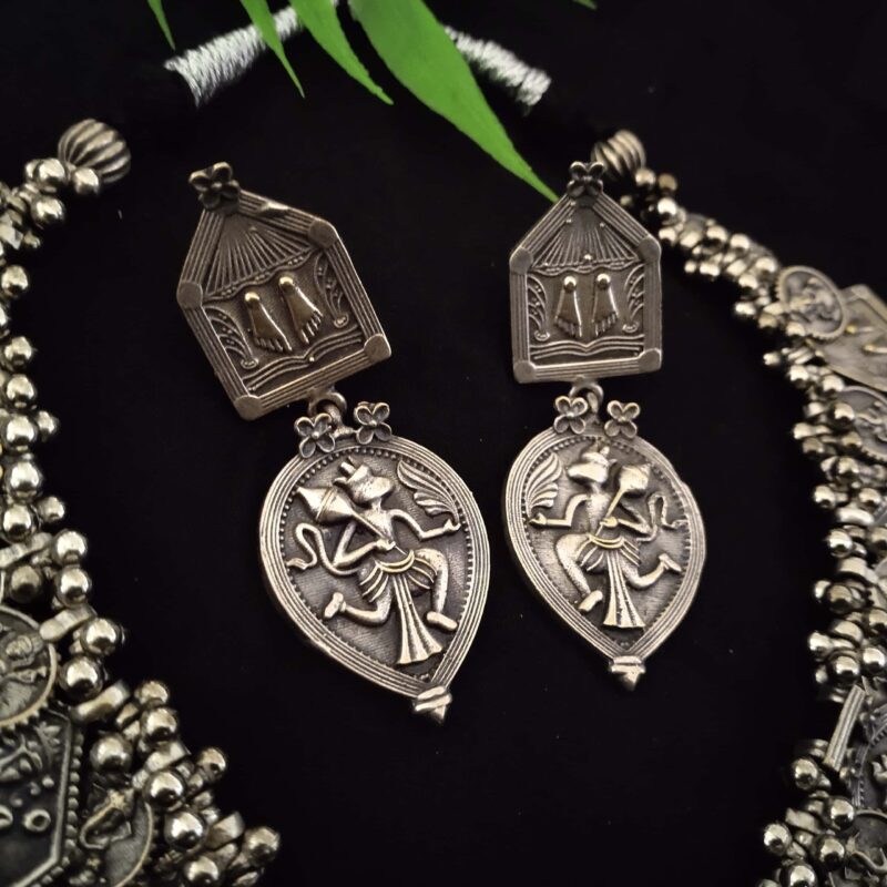 Intricate Indian silver traditional jewelry featuring detailed designs inspired by classical art and mythology, perfect for ethnic attire and special occasions.