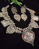 Silver Indian ethnic jewelry set with intricate mythological motifs and colored bead accents, perfect for traditional Indian fashion jewelry styling.