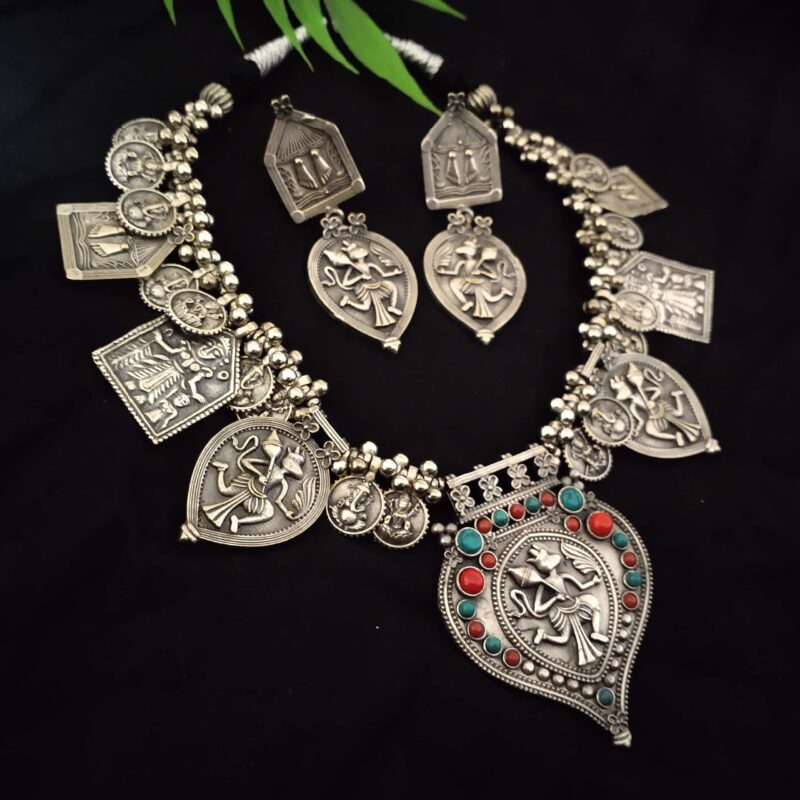 Silver Indian ethnic jewelry set with intricate mythological motifs and colored bead accents, perfect for traditional Indian fashion jewelry styling.