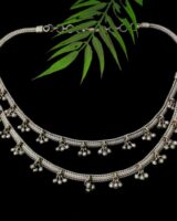 Intricate traditional Indian silver necklace with delicate bead accents, perfect for ethnic jewelry styling.