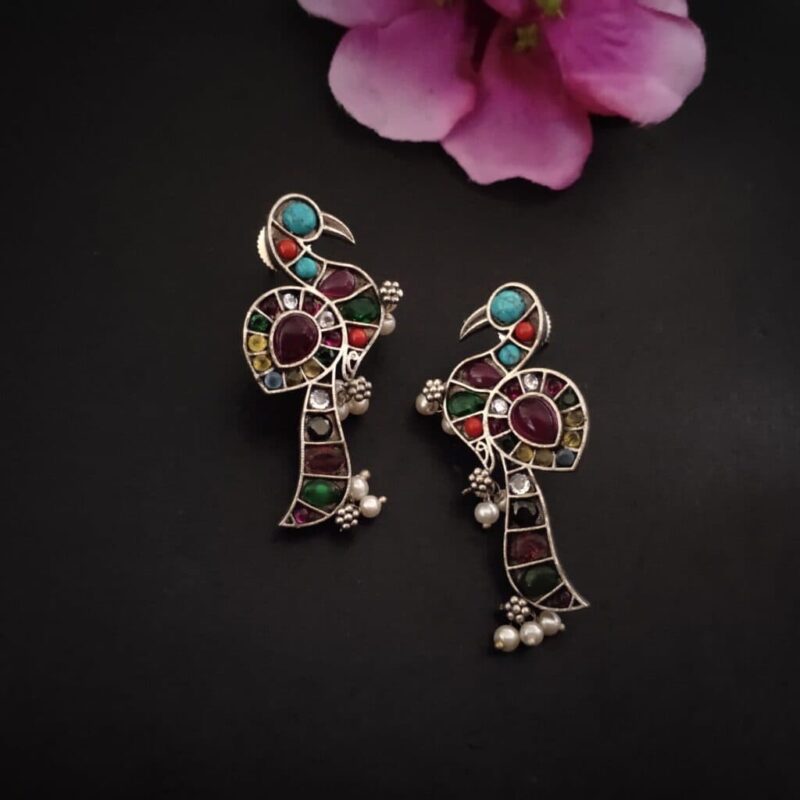 Colorful Indian jewelry earrings with intricate peacock design, gemstones, and pearl accents, perfect for traditional festive wear, from Kurabels Indian fashion jewelry collection.