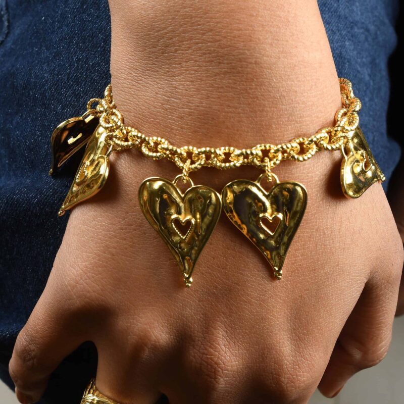 Elegant gold heart-shaped pendant charm bracelet showcasing intricate design and traditional Indian jewelry craftsmanship from Kurabels. Perfect for festive and special occasions.