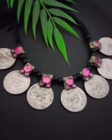 Shivling coin necklace with pink gemstone accents, traditional Indian jewelry piece, crafted for religious and cultural celebrations. Perfect for festive occasions and spiritual wear.