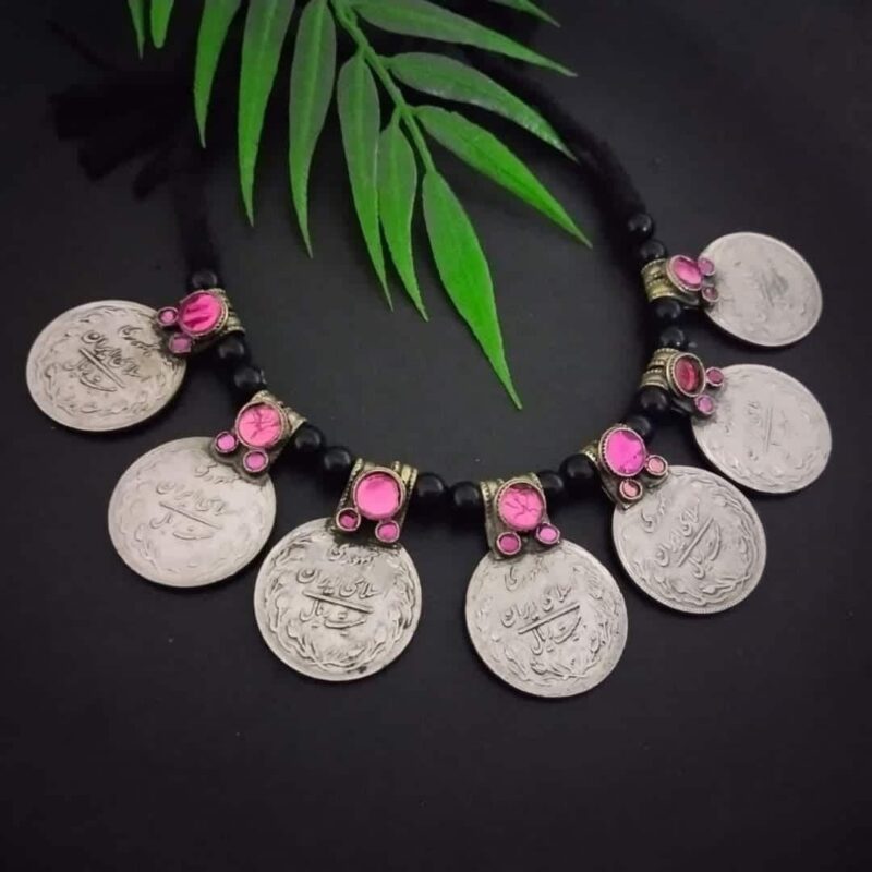 Shivling coin necklace with pink gemstone accents, traditional Indian jewelry piece, crafted for religious and cultural celebrations. Perfect for festive occasions and spiritual wear.