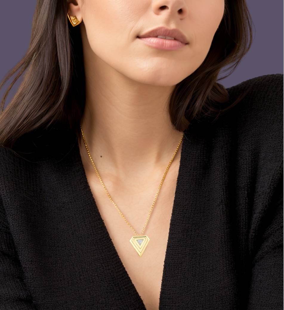 Elegant gold necklace with a geometric pendant featuring a sparkling stone, paired with matching gold earrings, showcasing Indian fashion jewelry for special occasions.