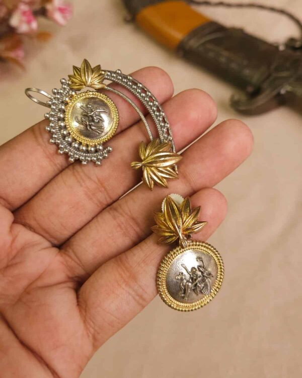 Intricate Indian jewelry set featuring gold and silver tones, with traditional deity coin medallion, floral leaf designs, perfect for festive or wedding occasions.