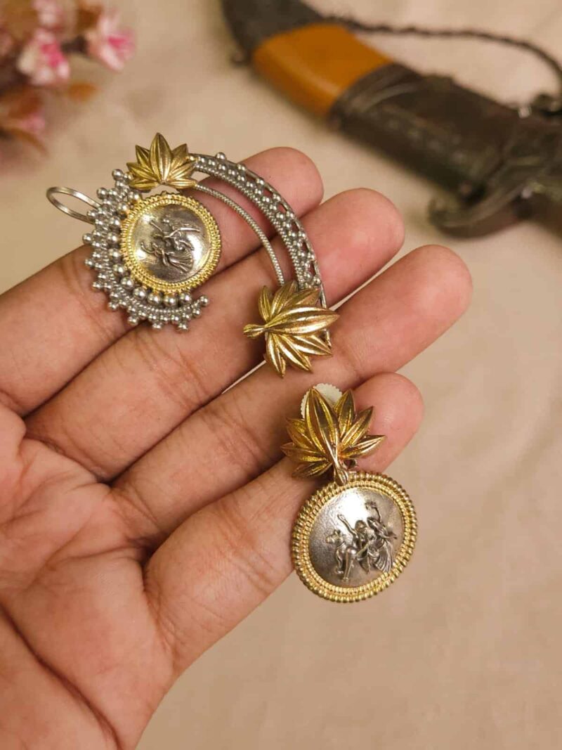 Intricate Indian jewelry set featuring gold and silver tones, with traditional deity coin medallion, floral leaf designs, perfect for festive or wedding occasions.