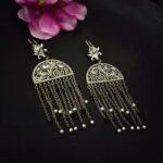 Intricate silver statement chandelier earrings with dangling chains and pearl accents, perfect for traditional Indian jewelry and festive occasions.