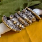 Intricate Indian fashion jewelry bracelets and bangles set featuring traditional silver and gold-toned designs with detailed craftsmanship, perfect for ethnic wear.