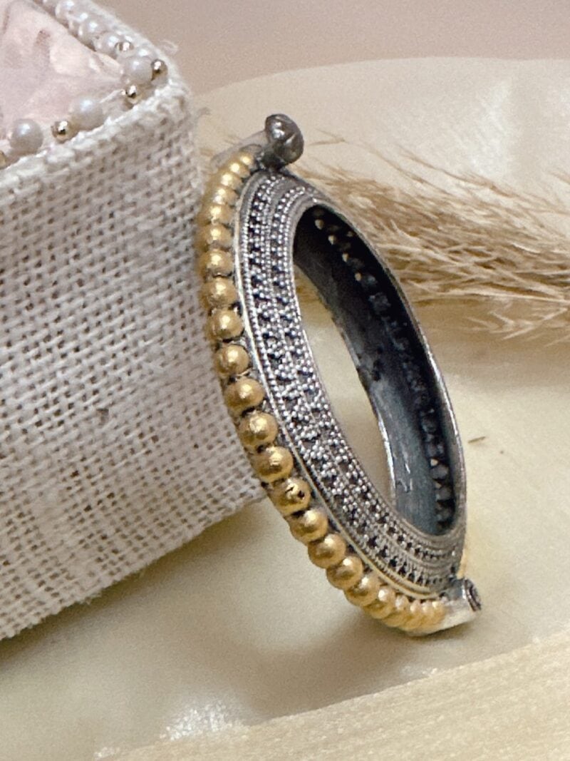 Intricate silver and gold Indian heritage jewelry bracelet featuring traditional bead and filigree designs, perfect for elegant cultural occasions and upscale jewelry collection.