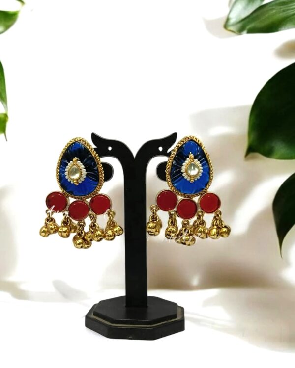 Elegant traditional Indian earrings with blue, red, and gold accents featuring teardrop-shaped gemstones and dangling bell charms, perfect for festive occasions.