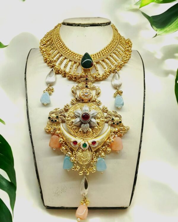 Intricate Indian traditional gold necklace with colorful gemstone accents, statement jewelry for ethnic or festive occasions, handcrafted jewelry from Kurabels.