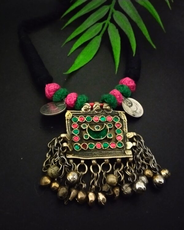 Colorful traditional Indian necklace with layered beads, intricate pendant design, silver charms, and metal hanging bells, perfect for ethnic jewelry styling and Indian festival outfits.