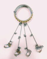 Intricate Indian jewelry set featuring a decorated bangles and rings with colorful enamel and ornate chain details, perfect for festive or traditional occasions.