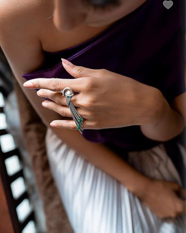 Silver jewelry ring with dangling multi-colored beads, styled for Indian fashion and accessories. Perfect for traditional and contemporary jewelry collection.