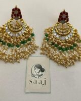 Beautiful traditional Indian jewelry earrings with gold metal, white and green beads, floral enamel detailing, and intricate design perfect for festive and bridal wear.