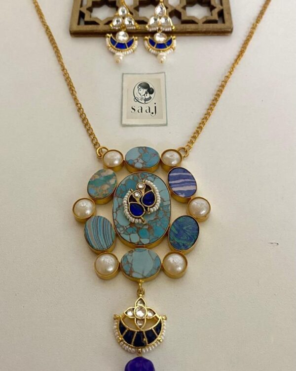 Elegant Indian fashion jewelry set featuring a statement necklace with turquoise and blue stones, paired with matching chandelier earrings, perfect for traditional or festive occasions.