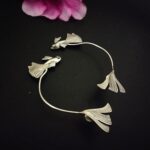 Elegant silver fish-shaped peacock feather jewelry bracelet, handcrafted Indian fashion jewelry with intricate detailing, perfect for traditional and contemporary Indian outfits.