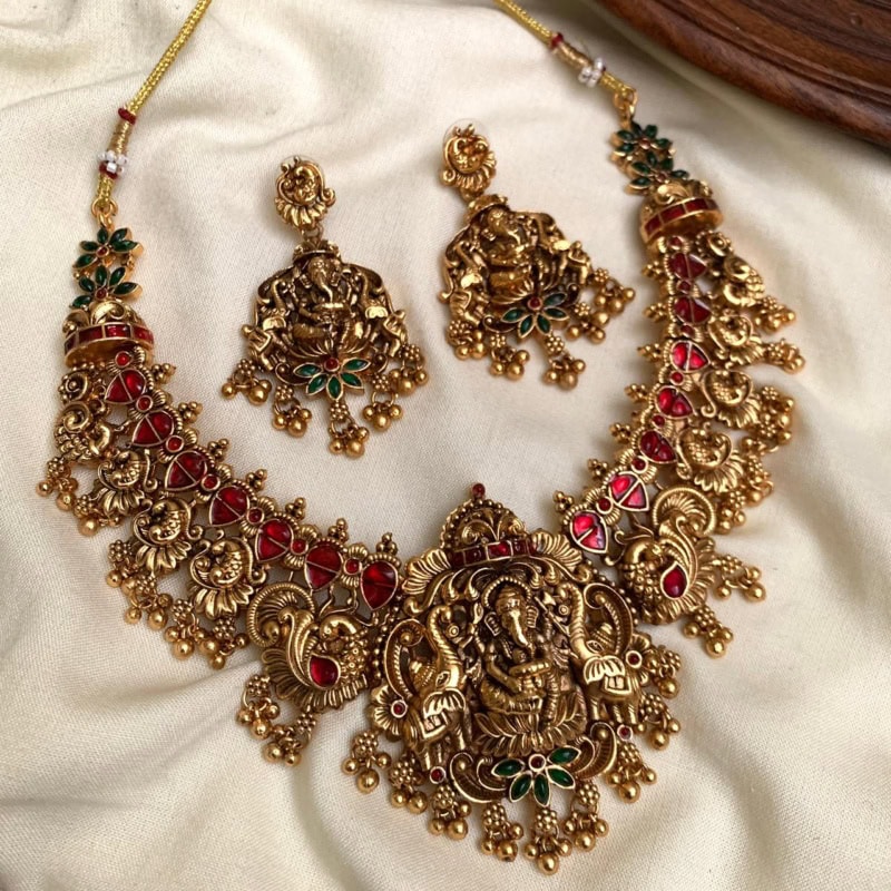 WhatsApp Image 2025-09-08 at 22.06.48_2b112fab Exquisite gold-plated Indian jewelry set with traditional pendant necklace and matching earrings adorned with red and green gemstones, perfect for festive and special occasions.