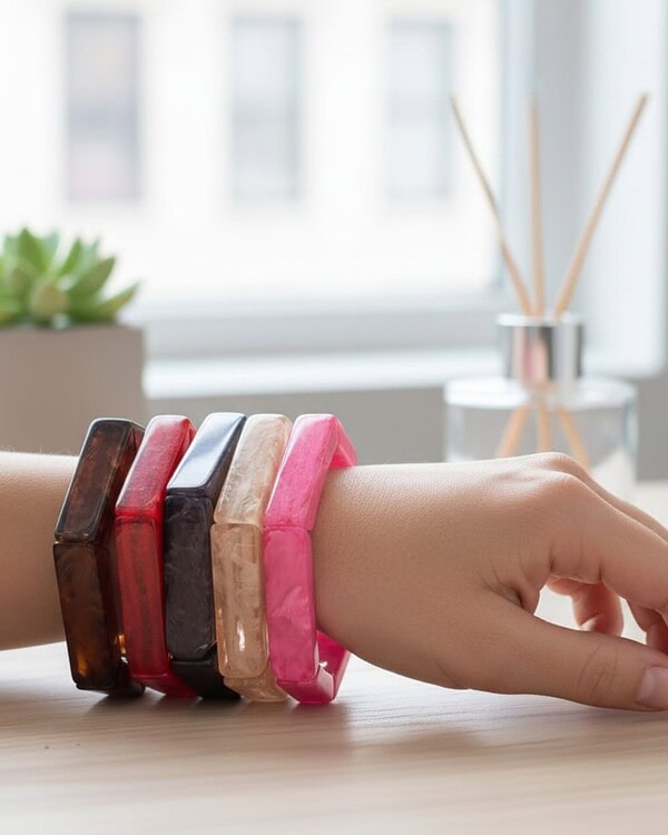 Colorful resin bangles on a woman's wrist, showcasing traditional Indian jewelry with a modern twist, perfect for accessorizing ethnic outfits and special occasions.