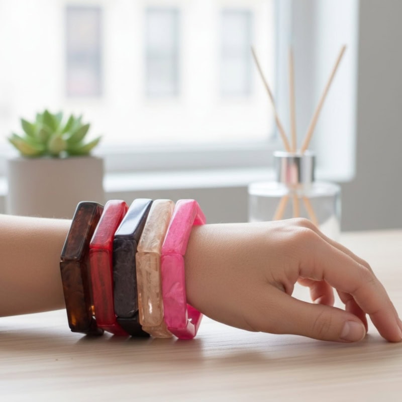 Colorful resin bangles on a woman's wrist, showcasing traditional Indian jewelry with a modern twist, perfect for accessorizing ethnic outfits and special occasions.