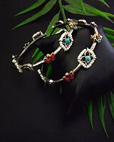 Intricate traditional Indian jewelry set featuring colorful stones, pearls, and silver craftsmanship, perfect for festive or wedding occasions.