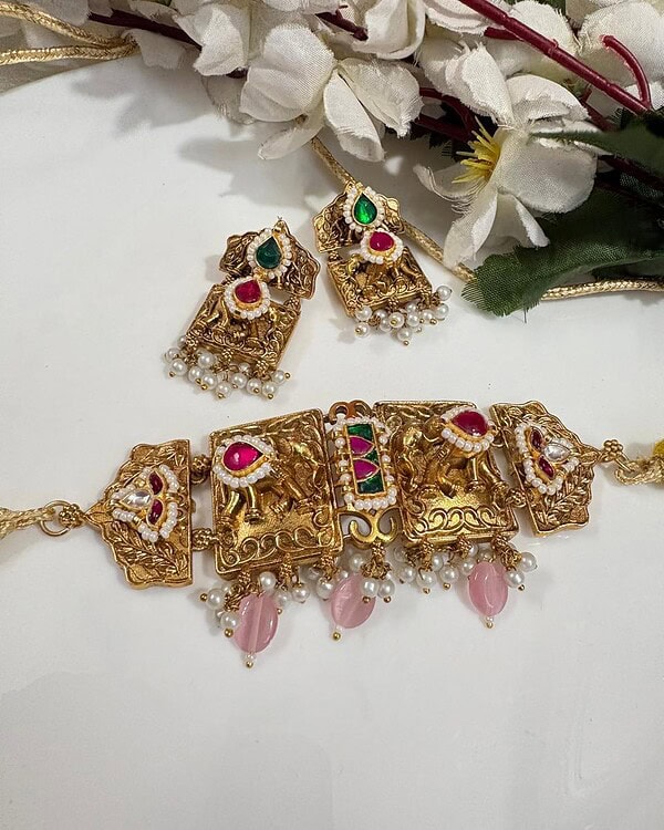 Elegant gold jewelry set with colorful stones, pearl accents, and intricate designs, perfect for Indian traditional celebrations and festivals.