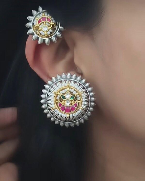 Elegant traditional Indian jewelry set featuring detailed silver earrings with colorful enamel and gemstone accents, perfect for festive or special occasions.