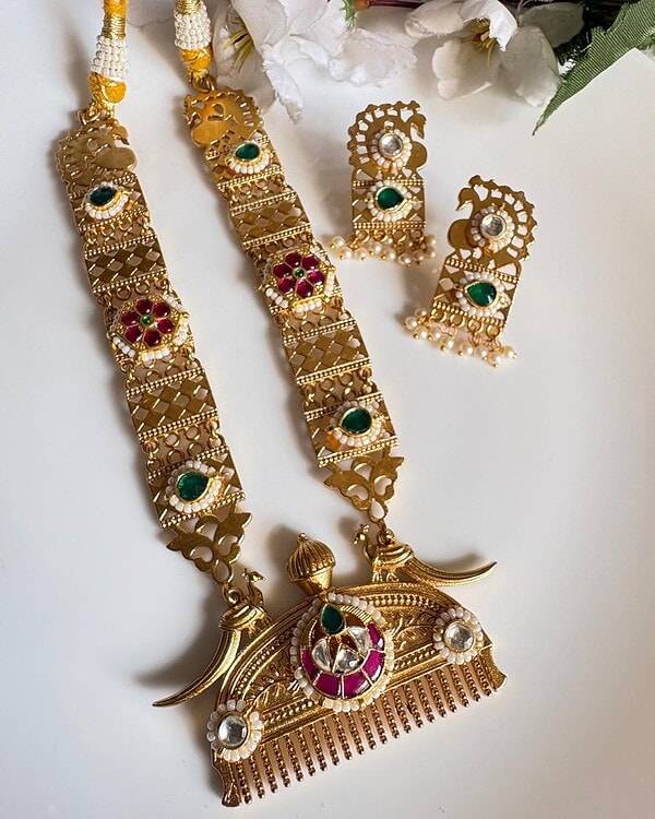 1. Gold-plated Indian jewelry set including necklace and earrings with green, red, and white stones, traditional design, perfect for festive occasions and cultural celebrations.