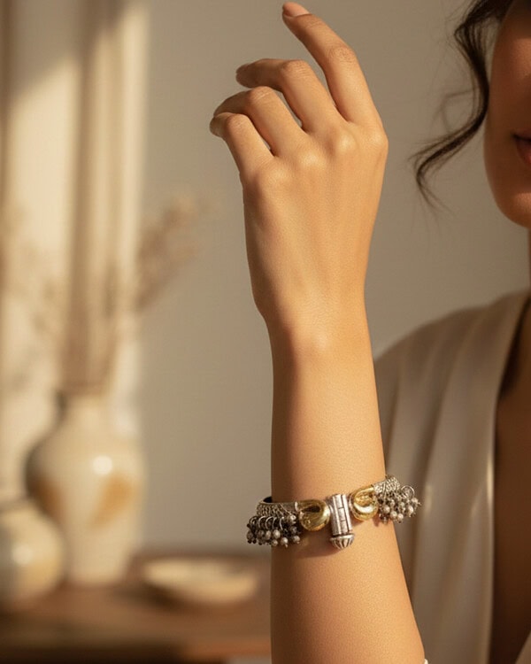 Elegant Indian jewelry bracelet showcasing intricate gold and pearl design, worn on a woman's wrist, perfect for festive or traditional occasions.