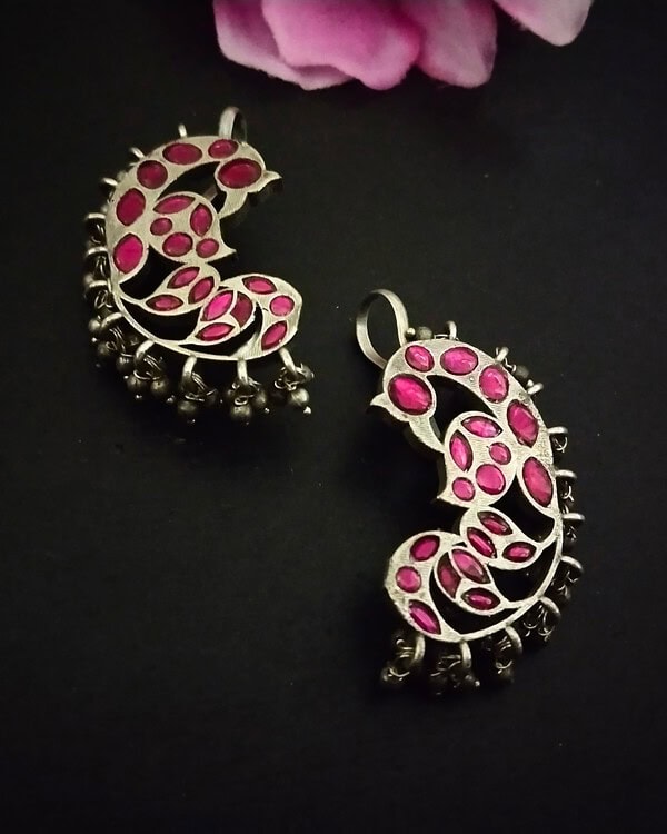 Elegant silver jhumka earrings with pink stones, traditional Indian jewelry perfect for festive occasions and weddings. Handcrafted jewelry showcasing Indian craftsmanship and vibrant design.