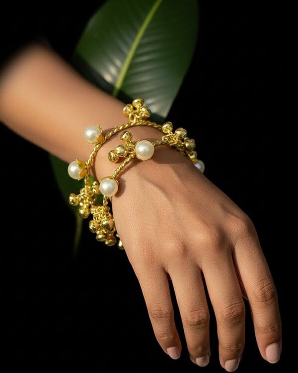 Luxurious gold and pearl bracelet with intricate design, perfect for Indian fashion jewelry styles and special occasions.