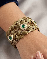 Elegant gold and green Indian jewelry bracelet with intricate design and gemstone accents.