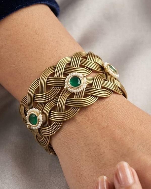 Elegant gold and green Indian jewelry bracelet with intricate design and gemstone accents.