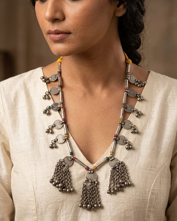 Elegant silver jewelry featuring intricate charms and vibrant beads, perfect for traditional Indian attire and special occasions.