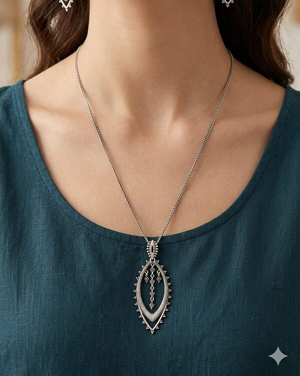 Elegant Indian jewelry featuring intricate silver earrings and matching necklace, perfect for traditional or festive occasions.