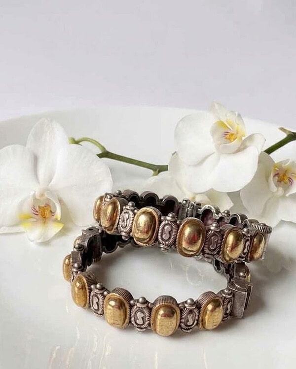 Elegant Indian jewelry bracelets featuring gold and silver tones with intricate designs, perfect for traditional and festive occasions.