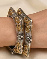 Elegant gold and silver Indian bangles with intricate floral and swirl designs, perfect for festive occasions and traditional attire.