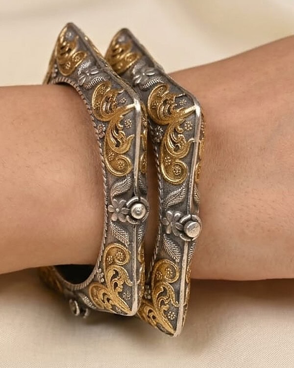 Elegant gold and silver Indian bangles with intricate floral and swirl designs, perfect for festive occasions and traditional attire.