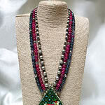Beautiful multi-strand beaded necklace with a traditional pendant featuring a decorated elephant motif, perfect for festive occasions and cultural celebrations.